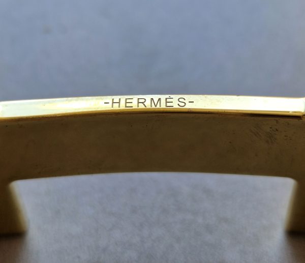 Boucle de ceinture Hermès Quizz en métal rouge et doréBoucle de ceinture Hermès Quizz en métal rouge et doré